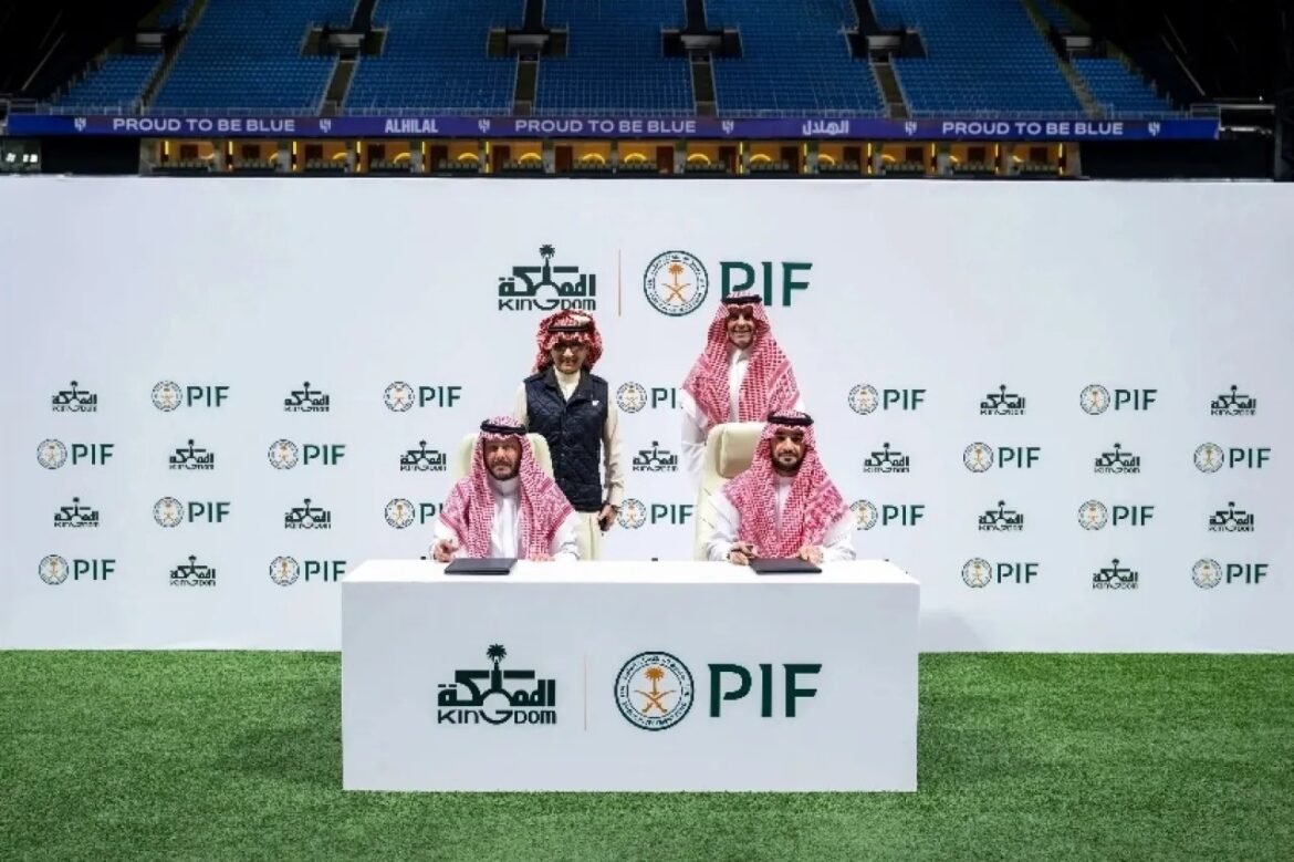 Three people sign documents at a formal ceremony on a white table in a stadium, with a backdrop of PIF and Kingdom logos.