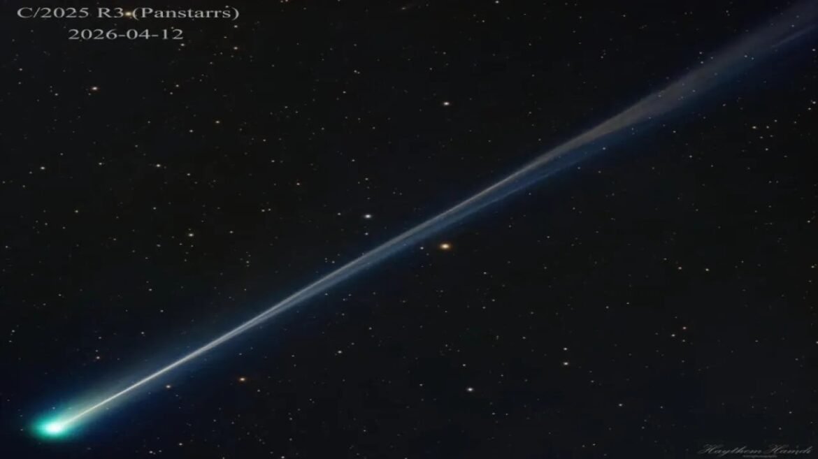Comet C/2025 R3 (Pan-STARRS) with a bright green tail sweeping across a starry sky (2026-04-12).