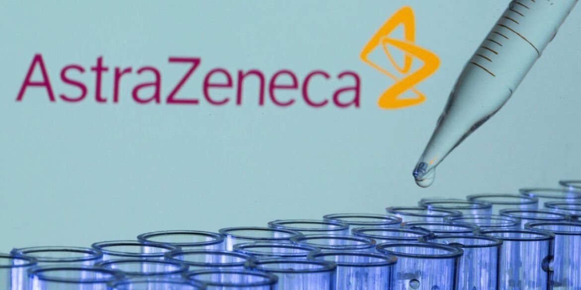 AstraZeneca logo with a pipette dropping liquid into a row of blue test tubes in a laboratory setting.