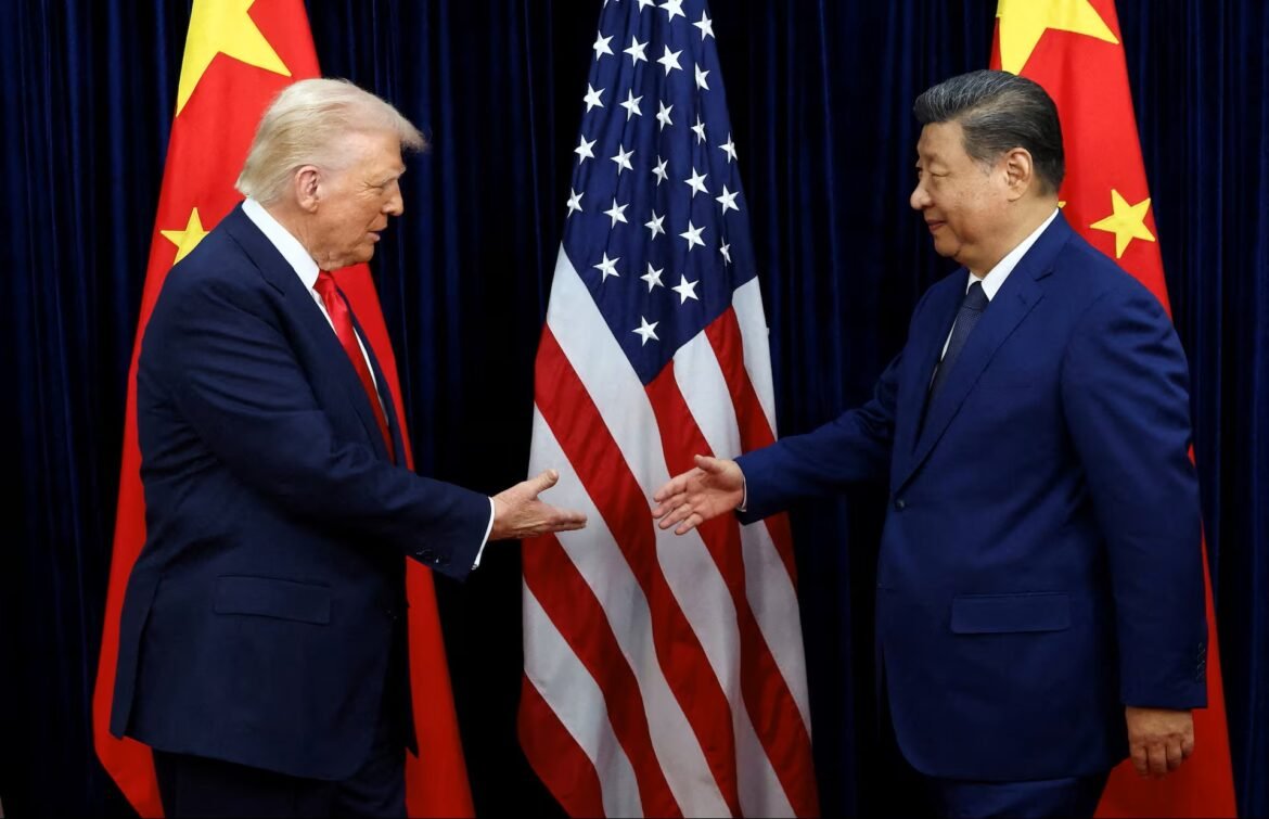 Trump and Xi Jinping shake hands in front of US and China flags behind them.