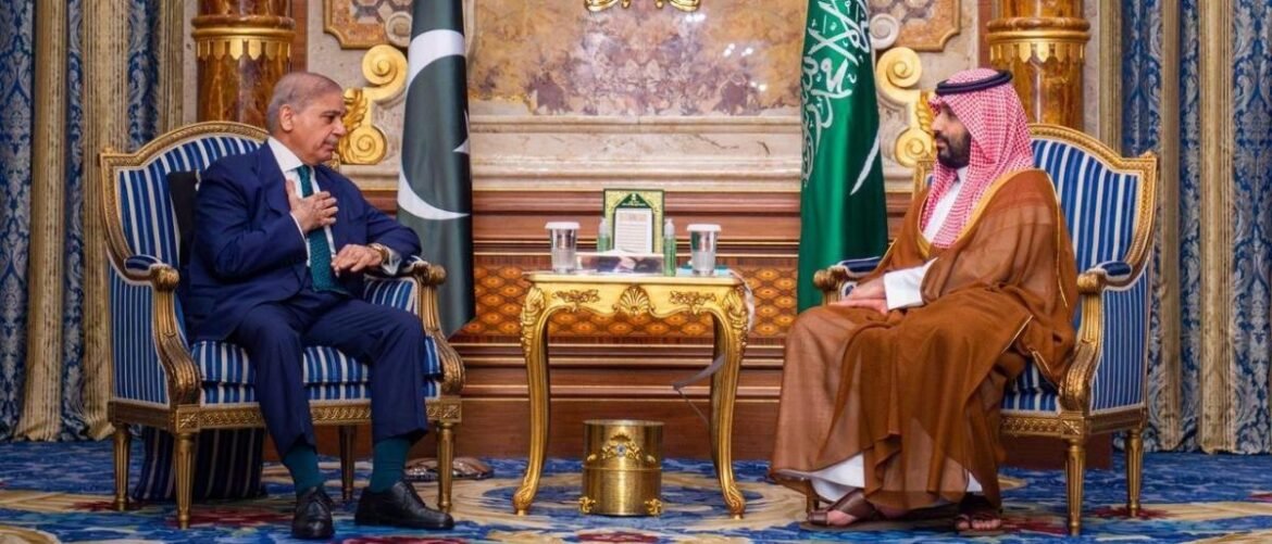 Two world leaders meet in a gilded, ornate room; flags behind them and a small golden table between them.