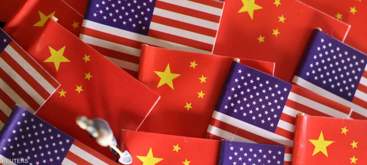Pile of American and Chinese flags overlapping in a colorful collage on a flat surface.