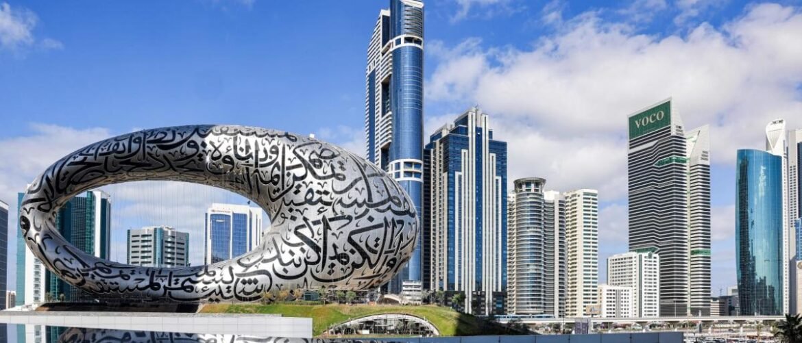 Futuristic city skyline with a large circular Arabic calligraphy sculpture in the foreground.
