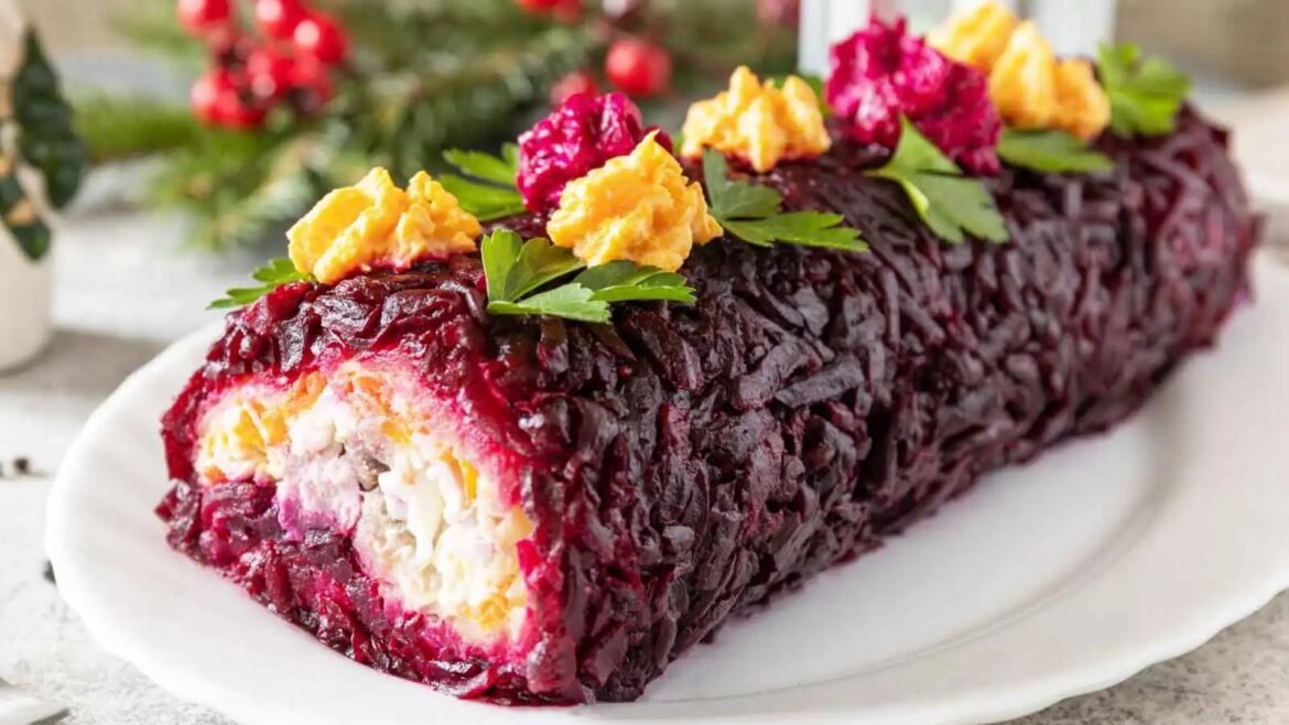 Beetroot-covered roulade with cream cheese filling, garnished with parsley on a white plate.