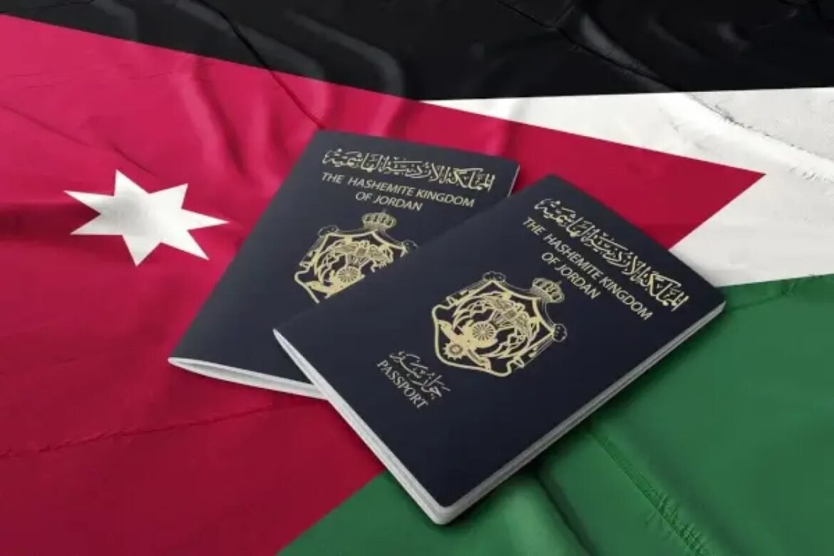 Two dark blue Jordanian passports with gold crest rest on a Jordan flag background.
