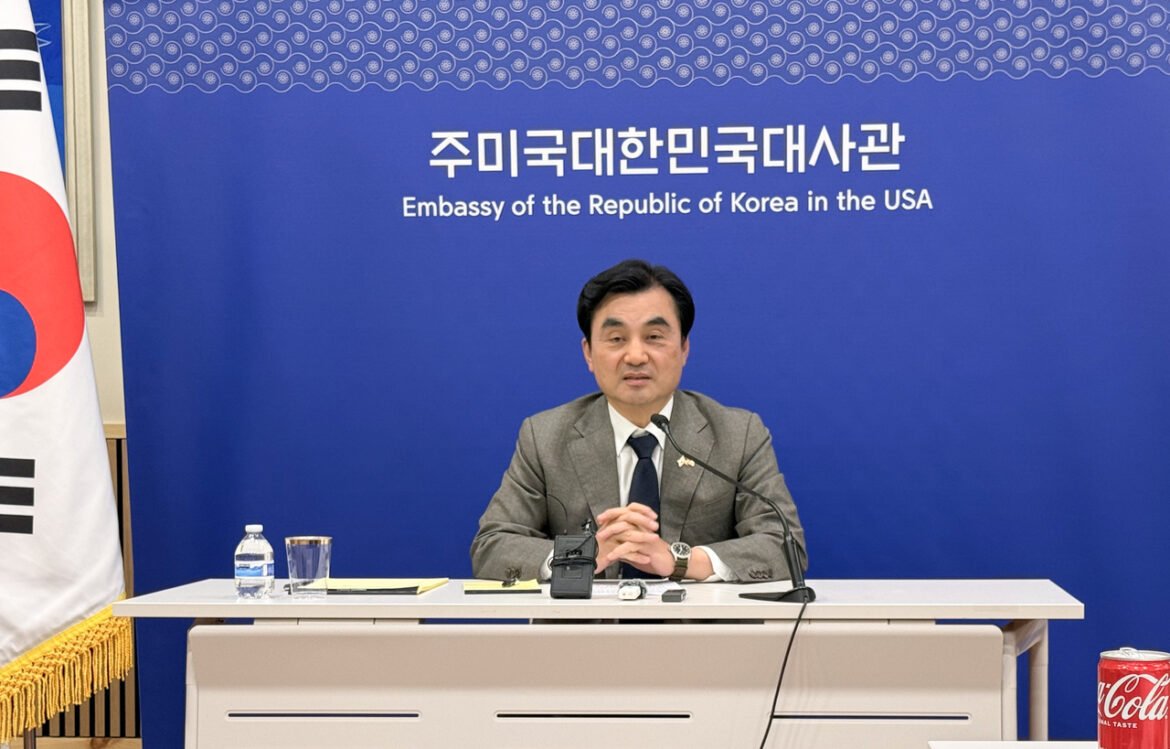 Official at a press briefing for the Embassy of the Republic of Korea in the USA, speaking into a microphone at a desk