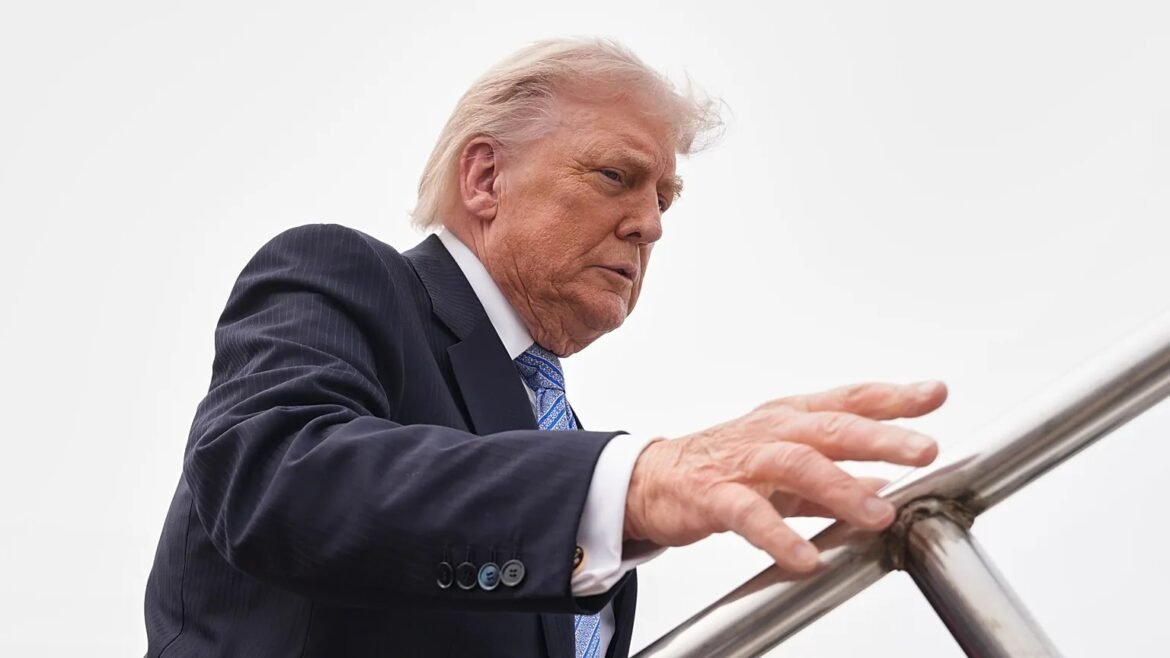 Older man in a dark pinstriped suit and blue tie descends a metal staircase, gripping the railing.