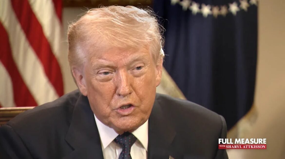 Close-up of former President Donald Trump speaking in a suit, with an American flag backdrop and a TV show's watermark in the corner.