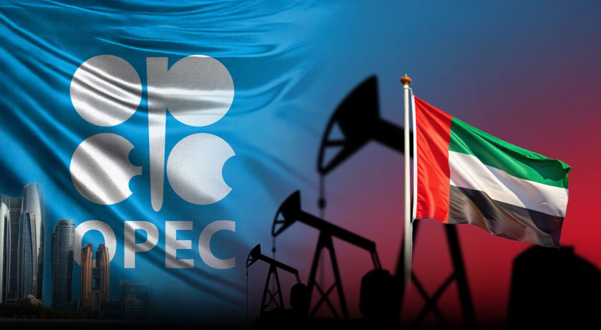 Blue OPEC flag flutters beside oil pumps and a city skyline, with a UAE flag in the background at dusk.