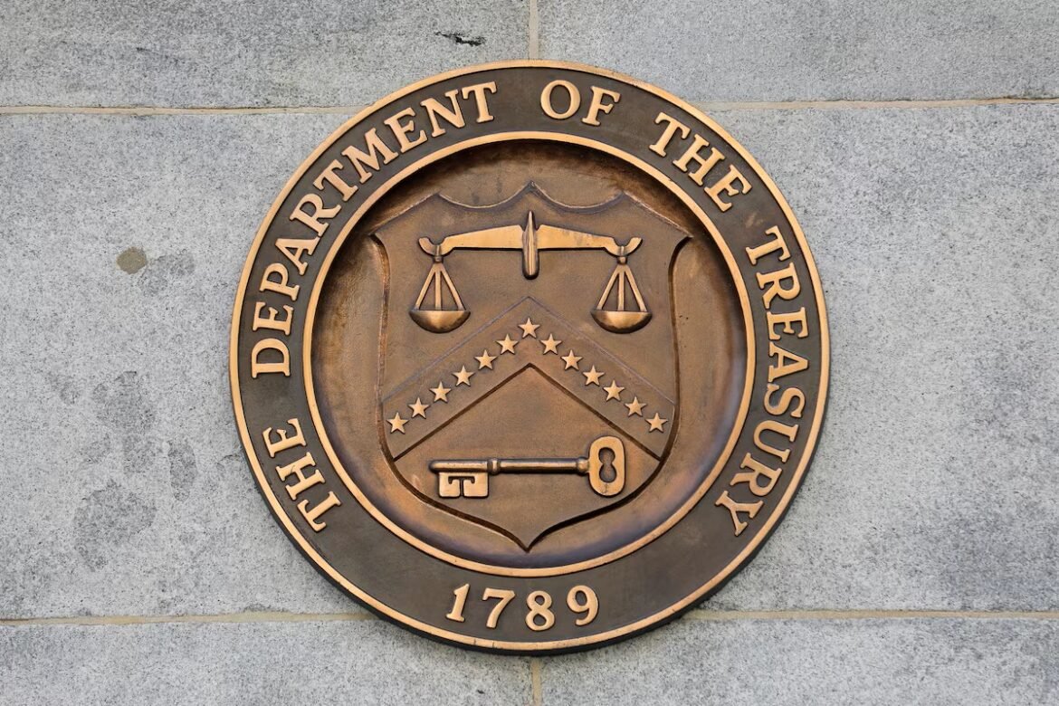 Seal of the U.S. Department of the Treasury: bronze medallion with scales, key, and star-chevron shield on a stone wall (1789).