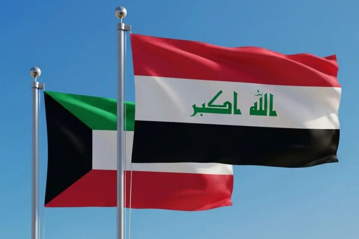 Two national flags fluttering in the wind against a blue sky: left is Sudan, right is Iraq (with Arabic script on the white stripe).