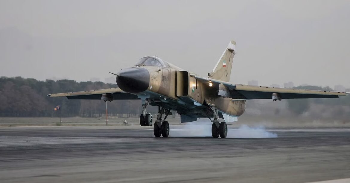 Tanf camouflaged fighter jet landing on a runway with smoke from the wheels, Indian flag on the tail fin as a distant landscape passes by.