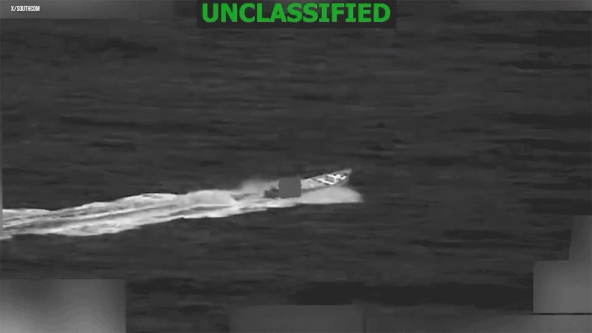 A fast motorboat speeding across dark water, leaving a white wake behind; top watermark reads UNCLASSIFIED.