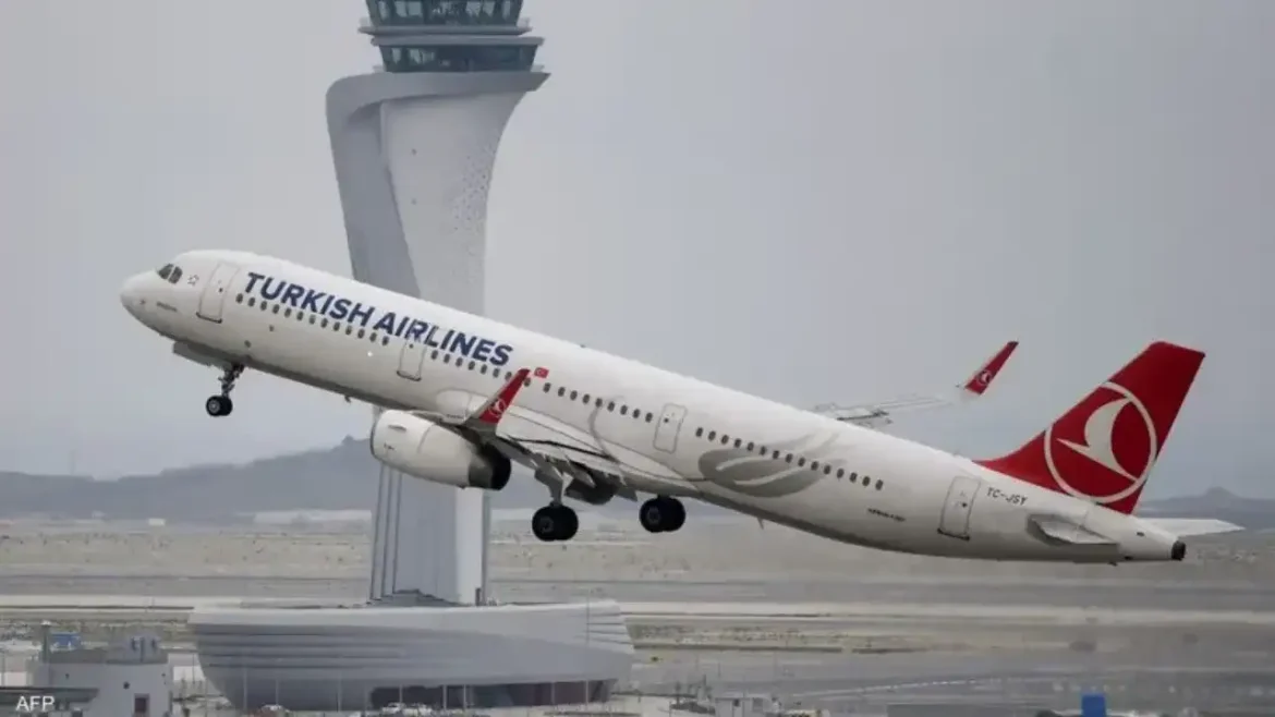 Turkish Airlines jet lifting off from a runway with a control tower in the background.