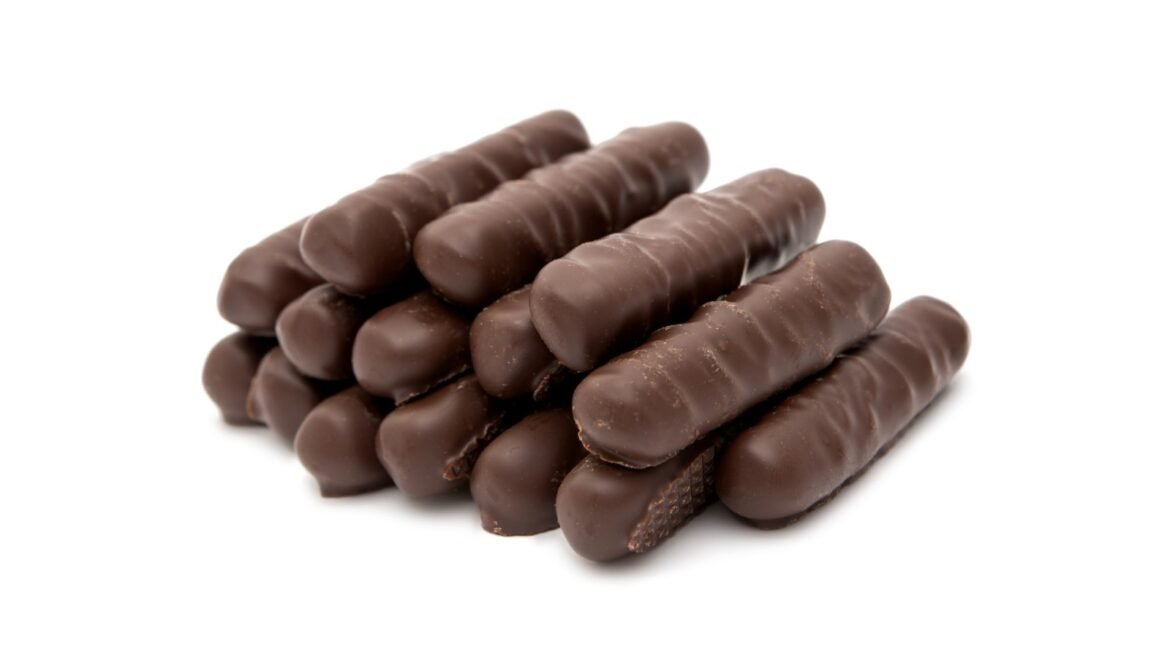Stack of chocolate-covered biscuit sticks on a white background.