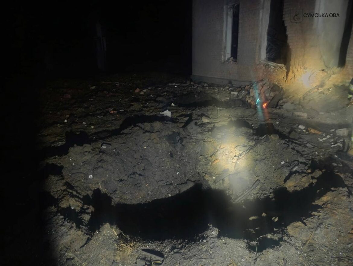 Nighttime view of a collapsed building with rubble and exposed brick, a firefighter in protective gear on the right.