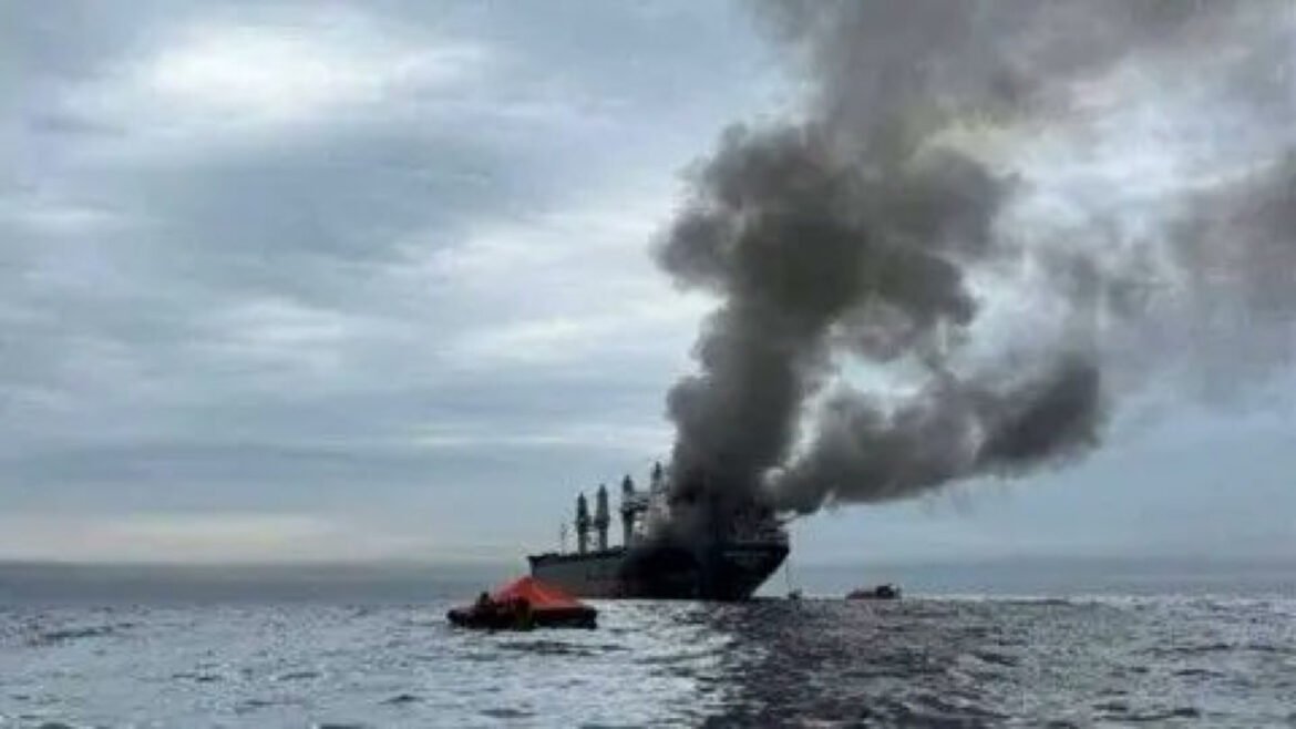 Large ship at sea emitting a tall plume of black smoke from its deck.
