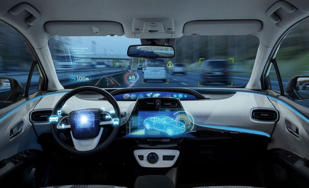 Futuristic car cockpit with a digital steering wheel and holographic dashboards displaying navigation and speed data. A HUD projects ahead with icons and a car diagram on a glass screen.