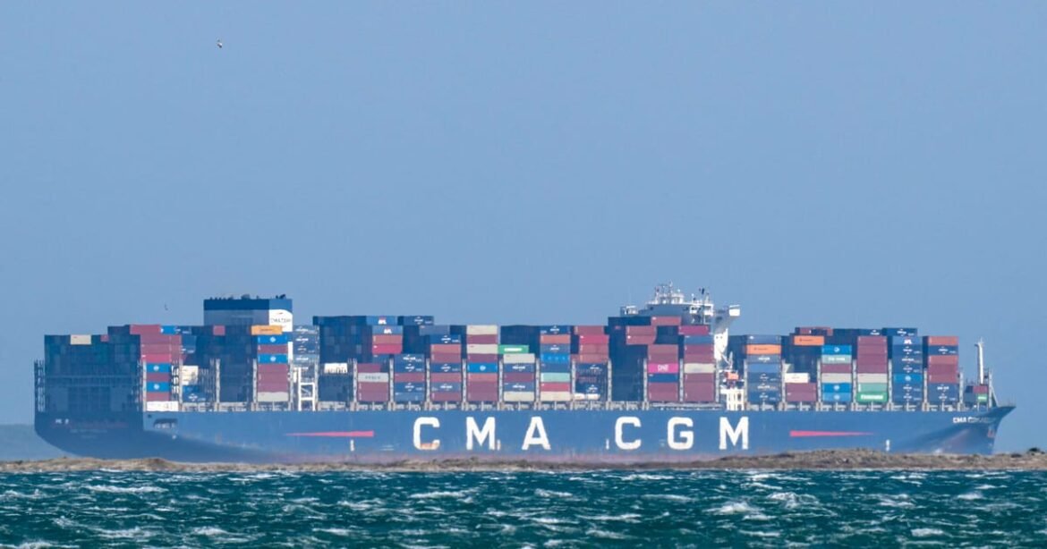 Container ship CMA CGM carrying multicolored shipping containers on a calm sea.