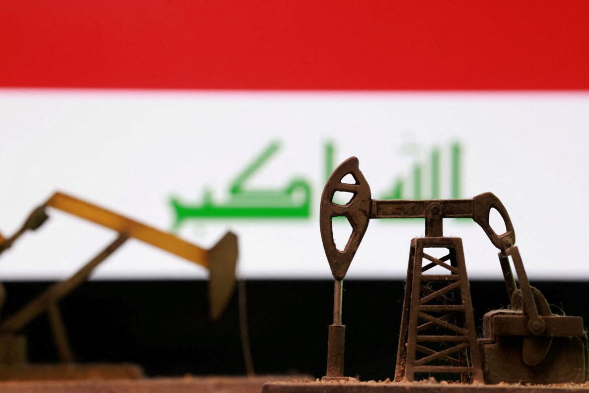 Close-up of a rusty toy oil pump jack in a miniature scene, with a red band above and a blurred green bar chart in the background.