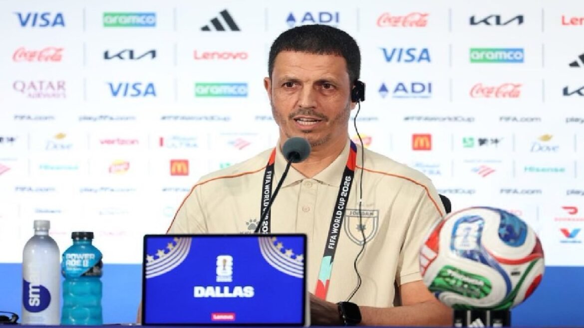 Male football official at a press conference with a Dallas World Cup 2026 display in front of him.