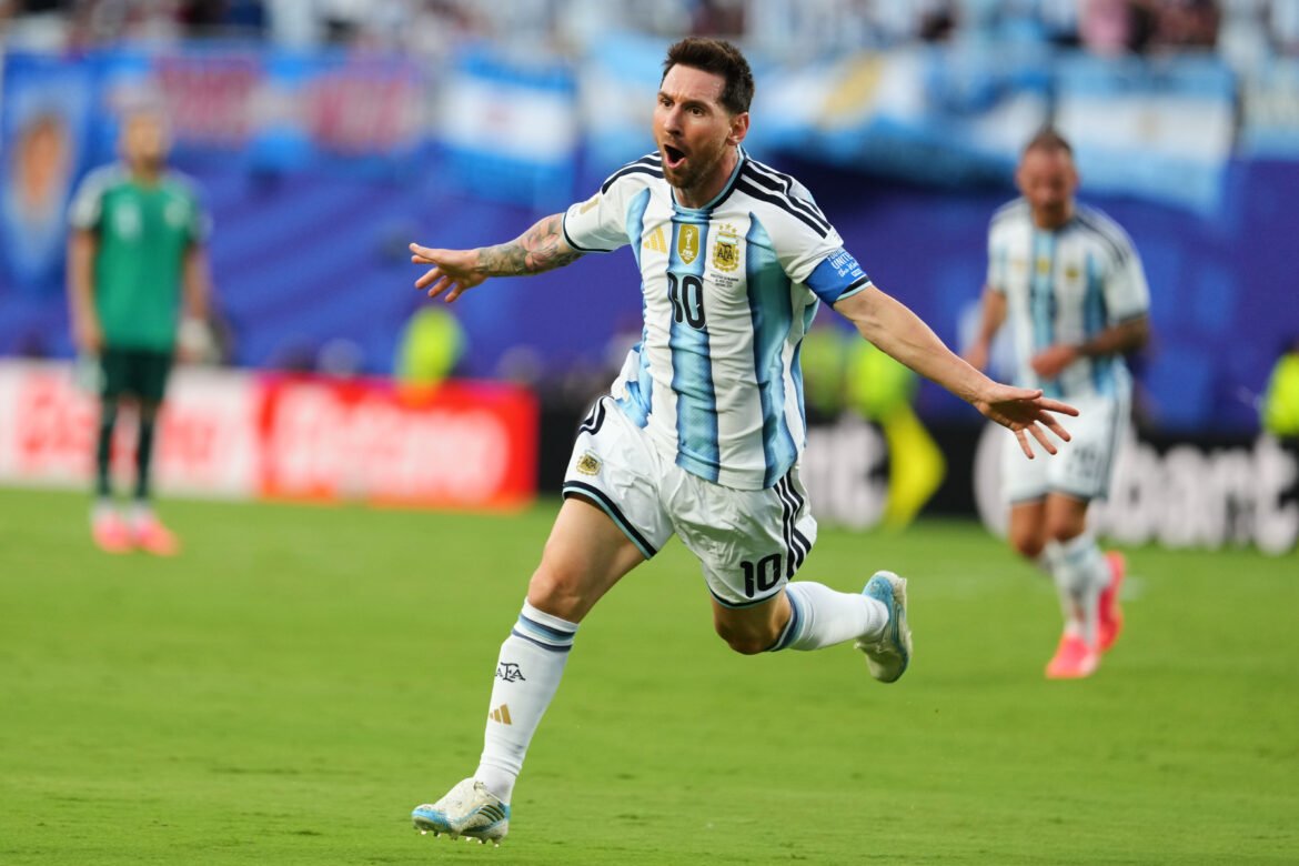 Argentina footballer Lionel Messi celebrating a goal, running on the field in white-and-sky blue stripes with his mouth open in jubilation