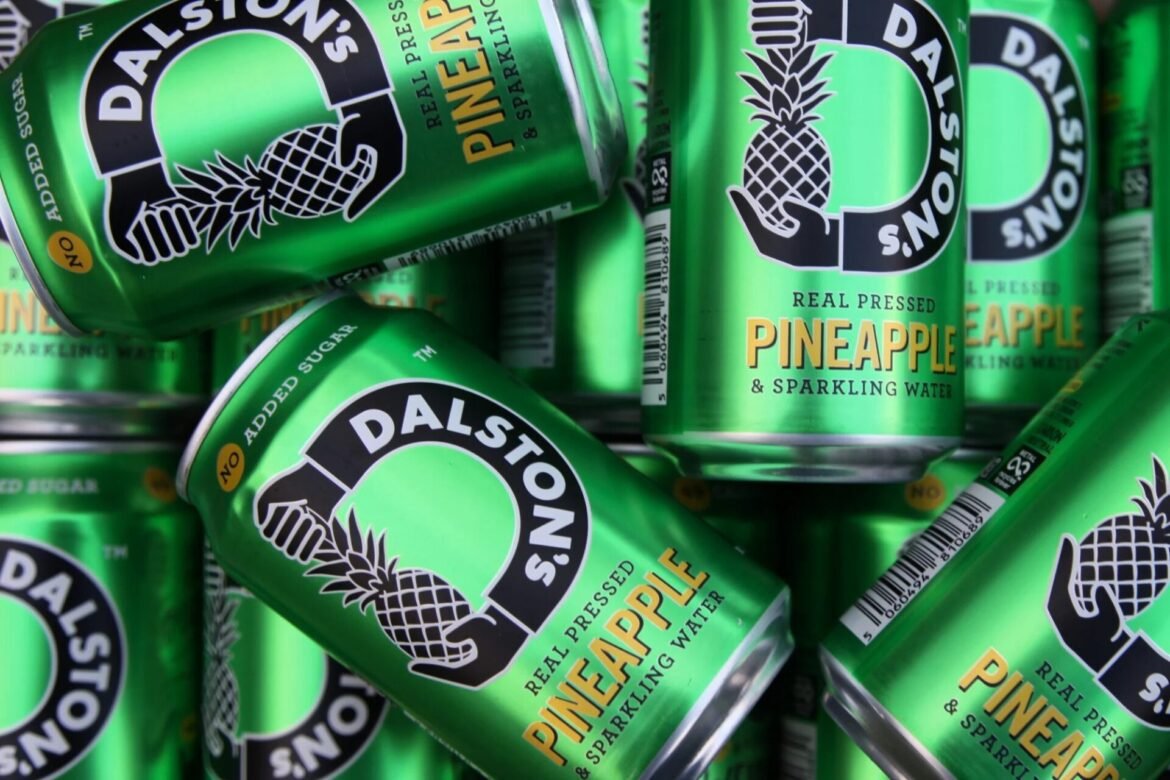 Cans of green pineapple-flavored sparkling water with a pineapple logo and bold 'PINEAPPLE' text on the can's front.