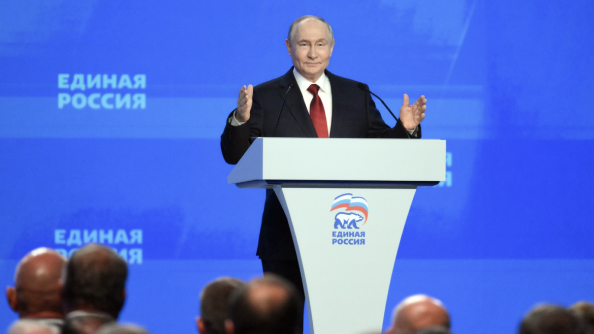 Russian President Vladimir Putin delivering a speech at a podium with the United Russia logo on stage, blue backdrop behind him.