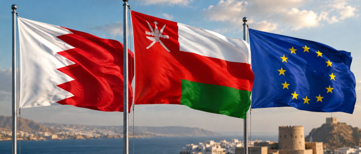 Flags of Bahrain, Oman, and the European Union fluttering over a coastal town with a fortress in the background.