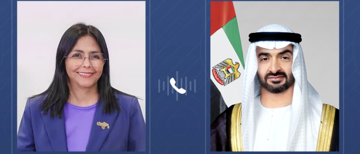 Side-by-side portraits: a smiling woman with glasses in a purple blazer on the left and a man in traditional Emirati dress with a UAE flag on the right, with a phone icon between them.