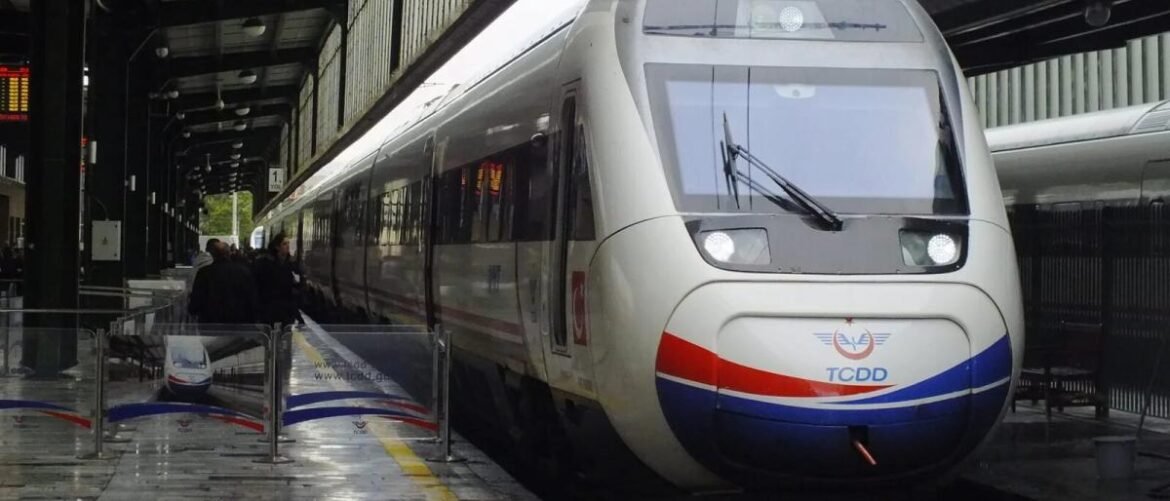 High-speed white train with red and blue stripe at a station, passengers boarding on a platform edge, modern windshield and headlights visible.