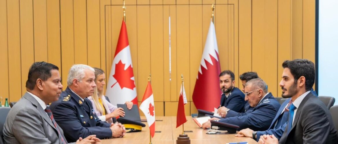 Officials from Canada and Bahrain hold a formal bilateral meeting at a conference table, with national flags between them.