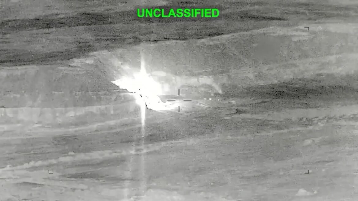 Infrared surveillance image showing a distant explosion on a barren landscape, with UNCLASSIFIED in green at the top.