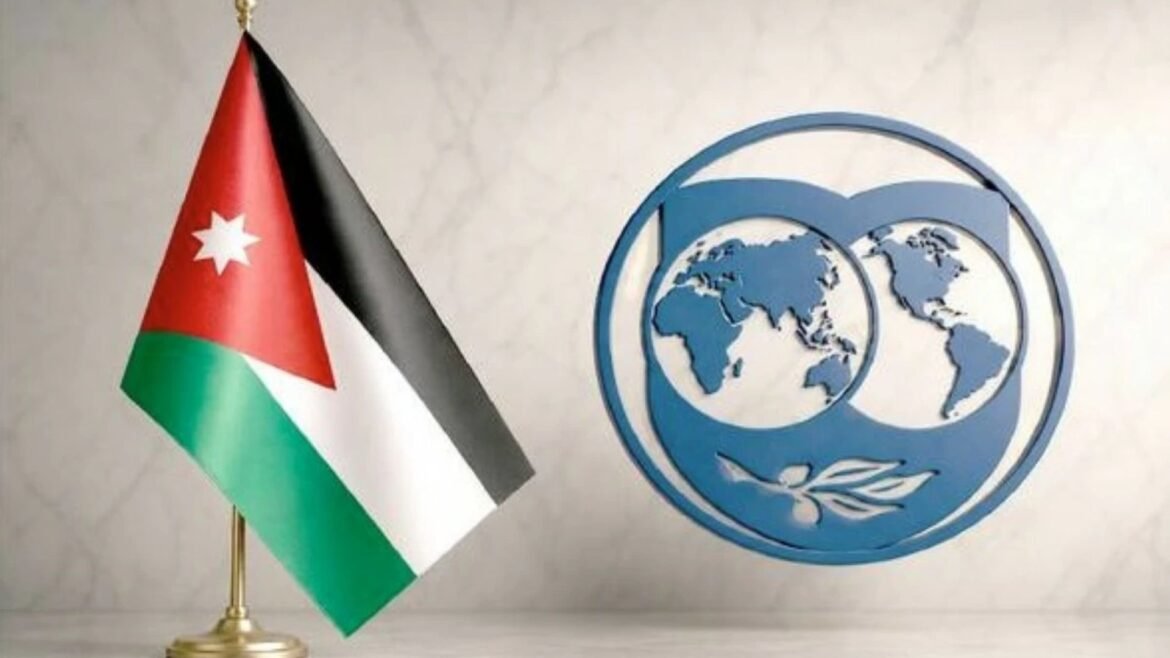 Jordan flag beside a blue United Nations emblem on a light wall.