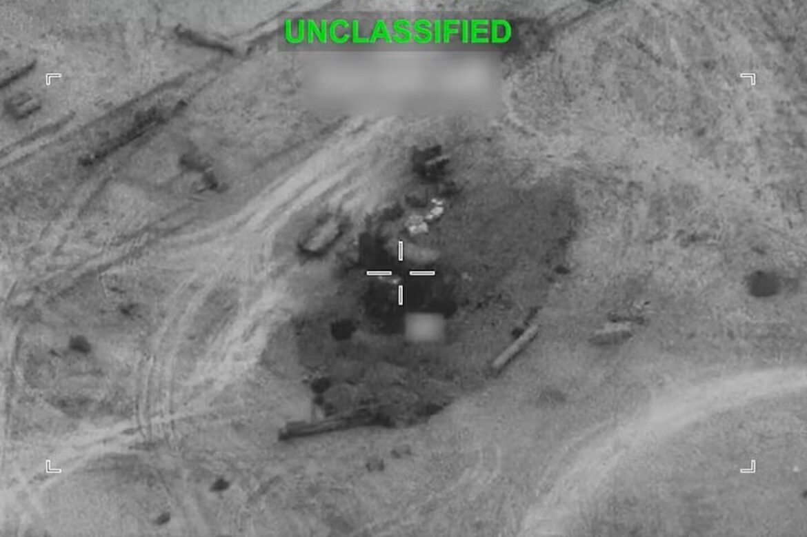 Aerial view through a targeting reticle of a cratered, rocky area with debris; green UNCLASSIFIED text at the top.