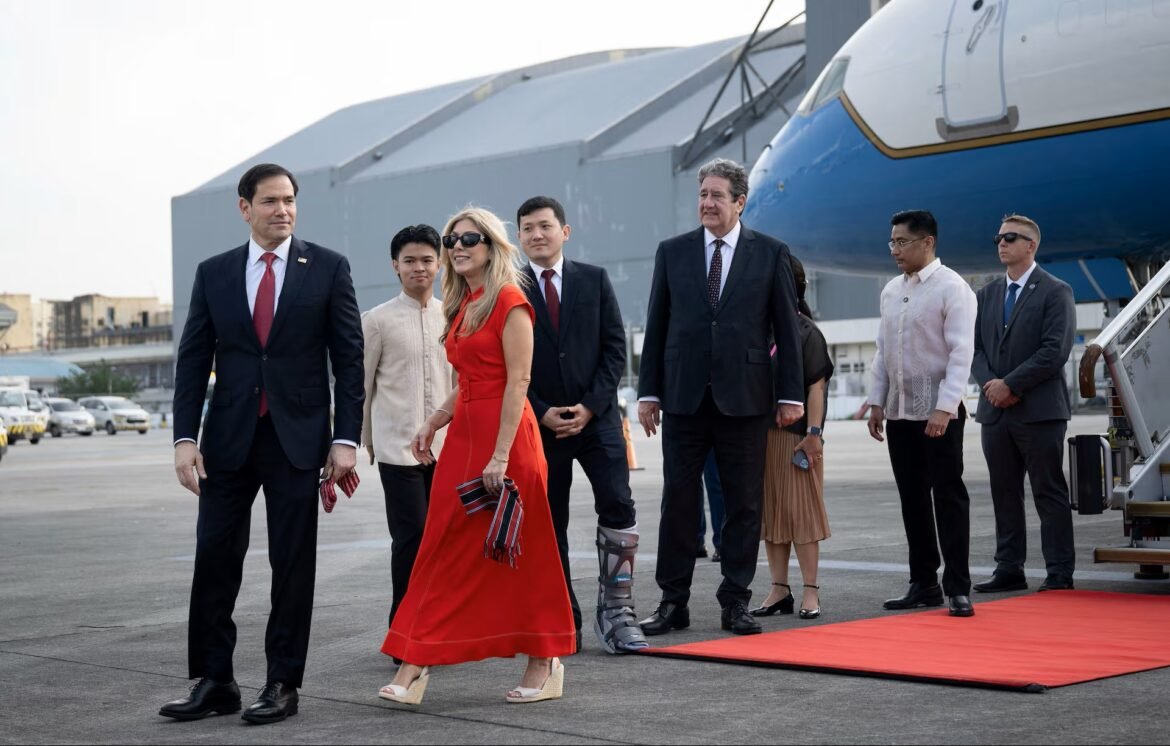 VIPs walking off a jet onto a tarmac with a red carpet and a blue airplane in the background