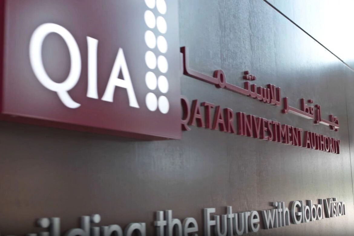 Close-up of a wall sign reading 'QIA' and 'Qatar Investment Authority' with Arabic text and the slogan 'The Future with Global Vision' behind it.