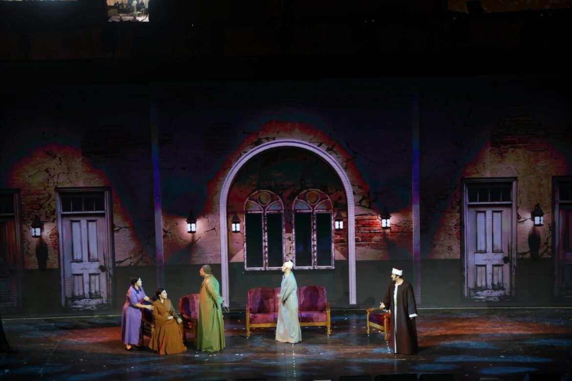 Theater stage with a painted crumbling building backdrop, arched doorway, and three windows; five actors in period robes stand or sit around purple chairs during a performance.