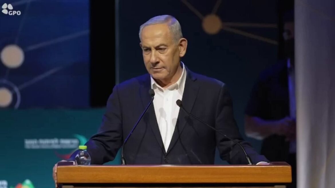 A suited man delivering a speech at a wooden podium with two microphones on stage. (Informative)