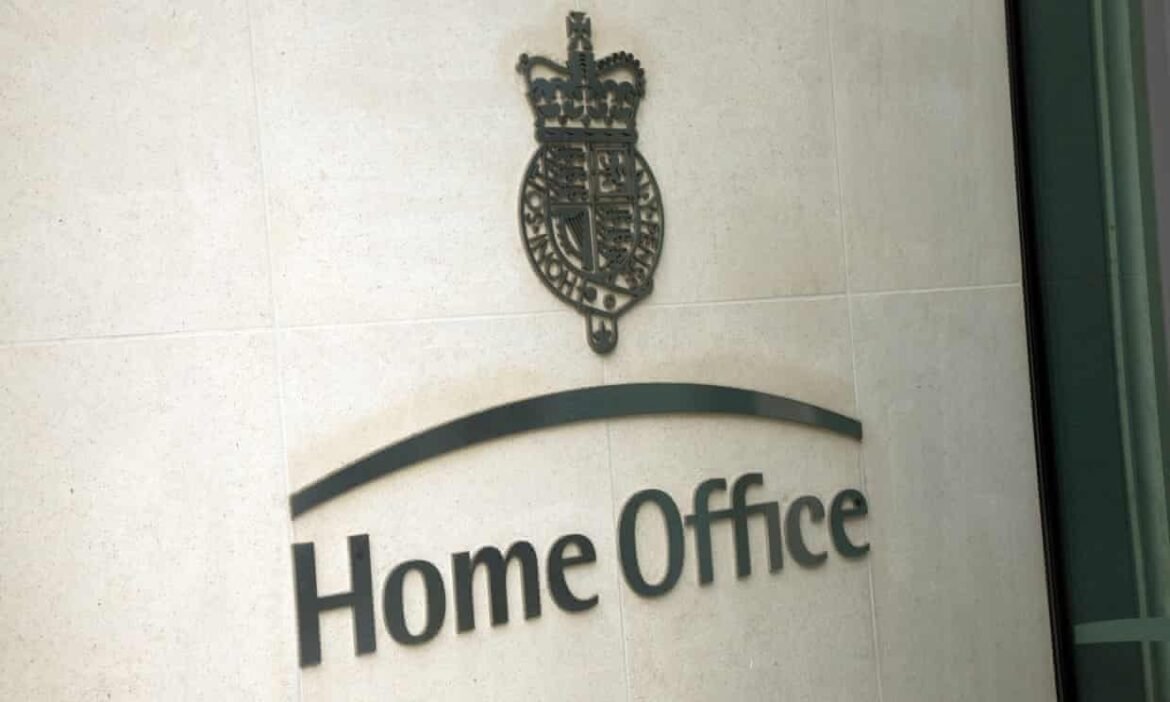 UK Home Office sign with crown emblem on a light wall