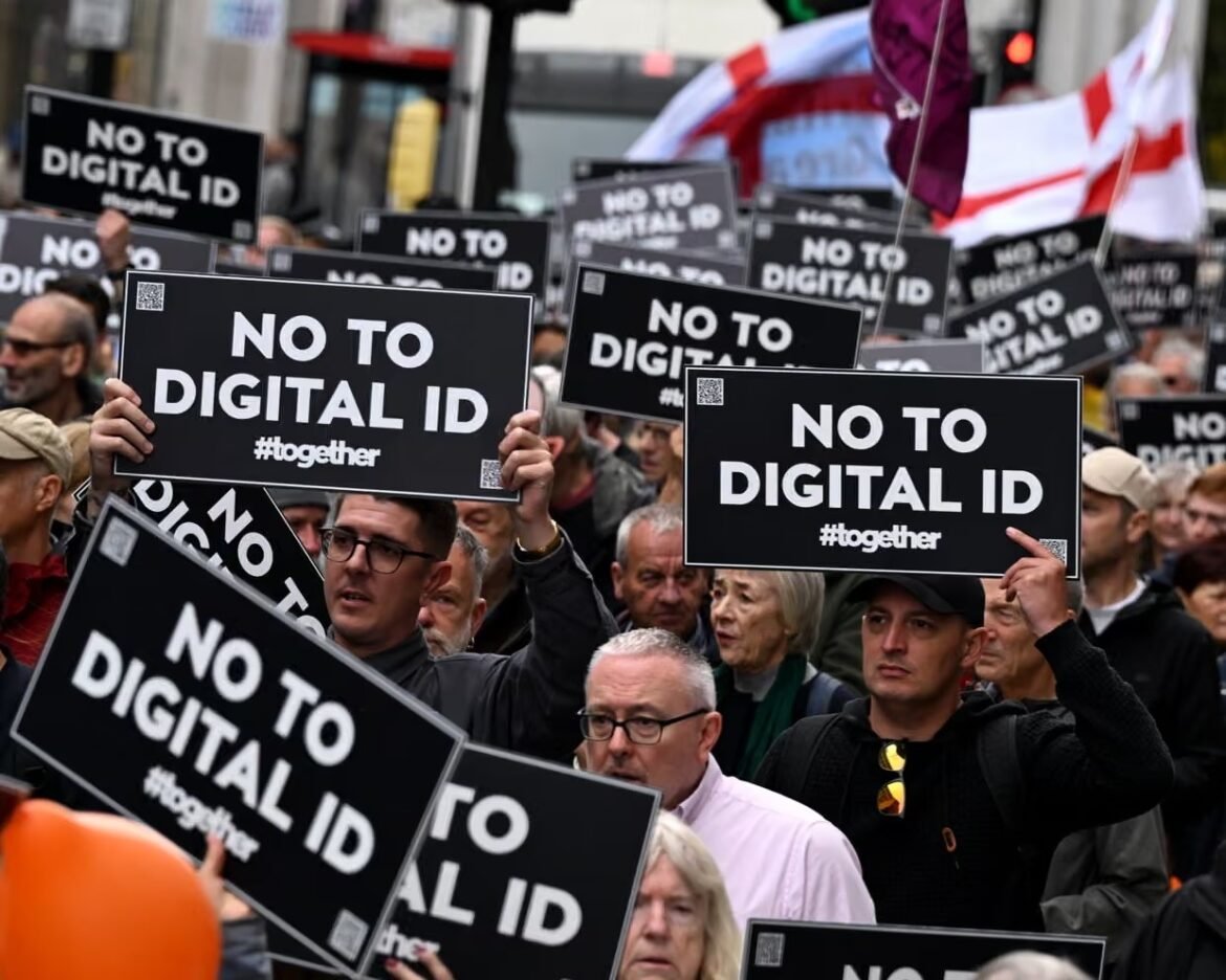 Crowd of protesters on a city street holding black signs that read 'NO TO DIGITAL ID' with '#together'.