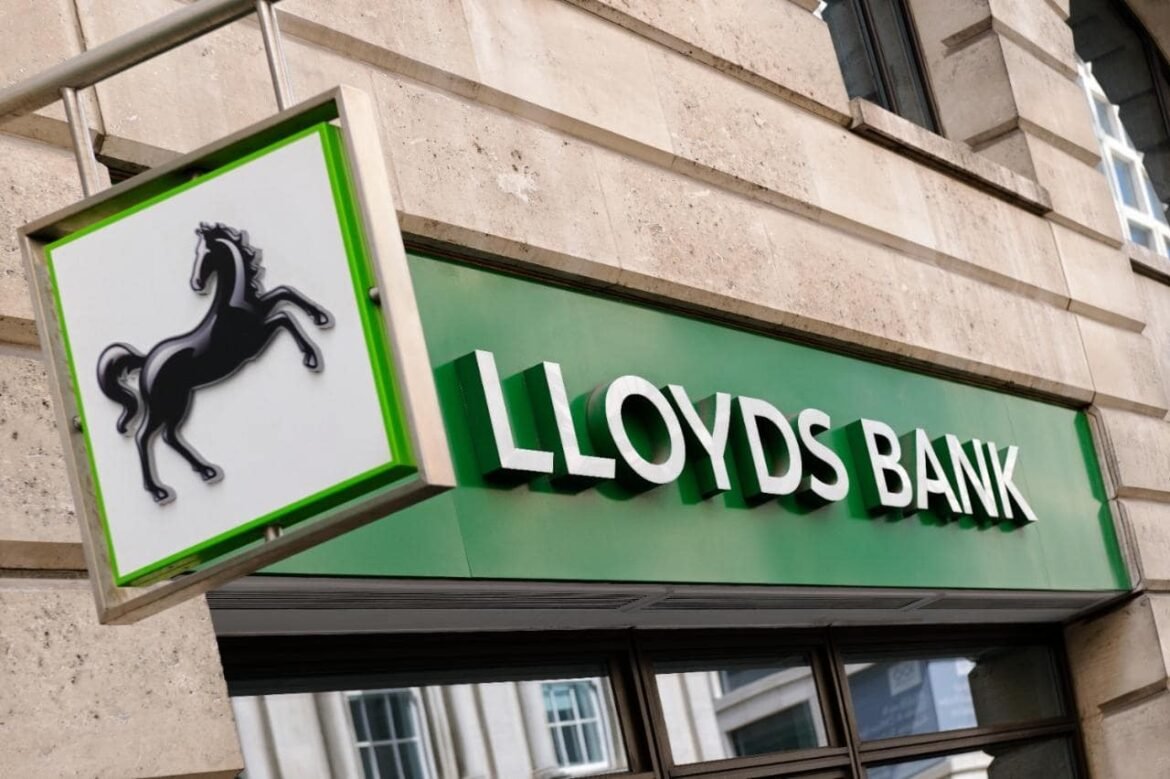 Lloyds Bank storefront sign on a green panel with a black rearing horse logo to the left.