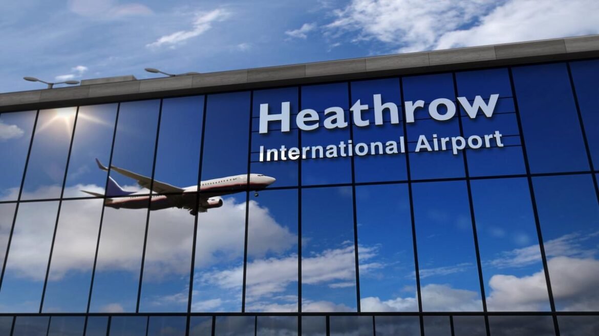 Glass-fronted Heathrow Airport building reflecting a flying passenger jet beside the words 'Heathrow International Airport'.