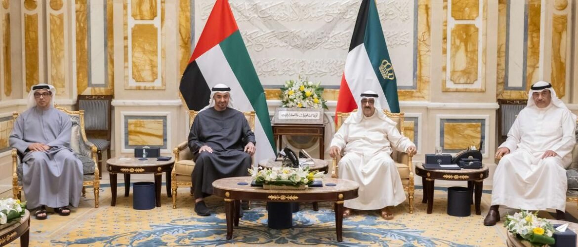 Four men in traditional Gulf attire sit on gilded chairs in an ornate room, with Palestinian and Kuwaiti flags behind them.
