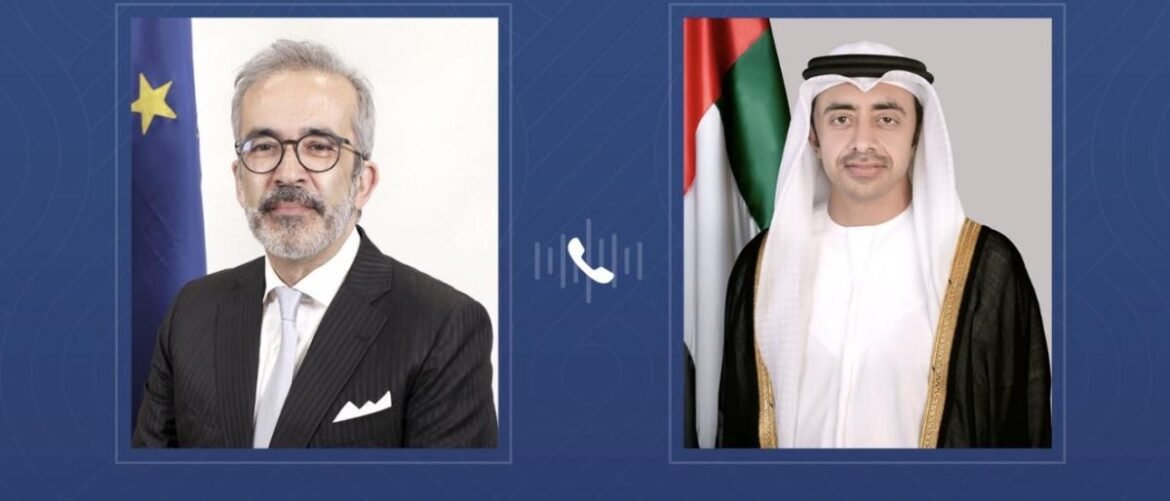 Two side-by-side portraits on a blue patterned background: a suited man with glasses on the left and a man in traditional Gulf attire on the right, with a phone icon between them.
