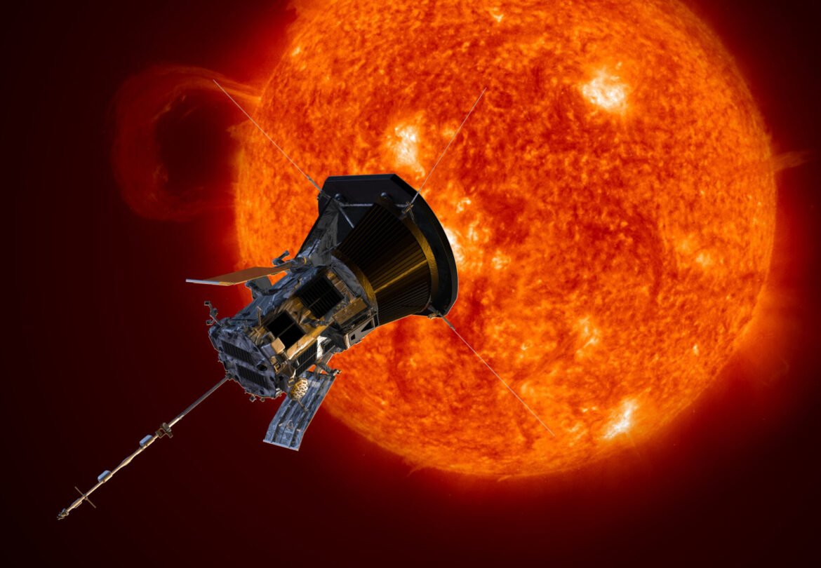 James Webb Space Telescope in the foreground with a bright orange Sun and corona behind it.
