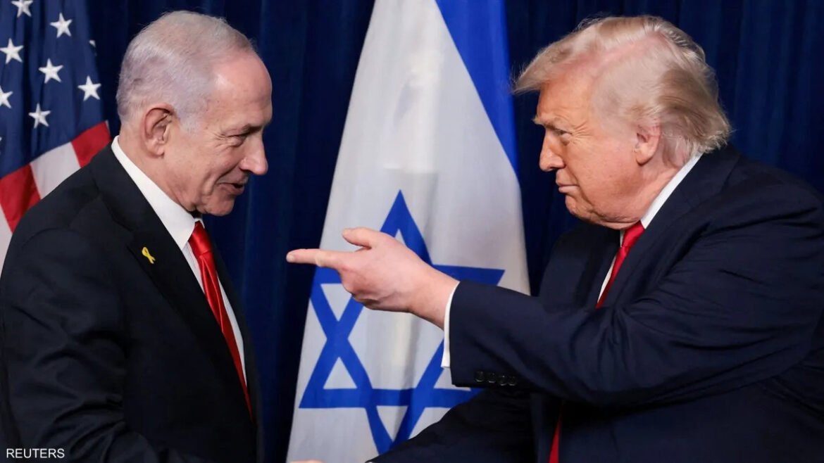 Two men in suits prepare to shake hands, with the U.S. flag and the Israeli flag in the background.