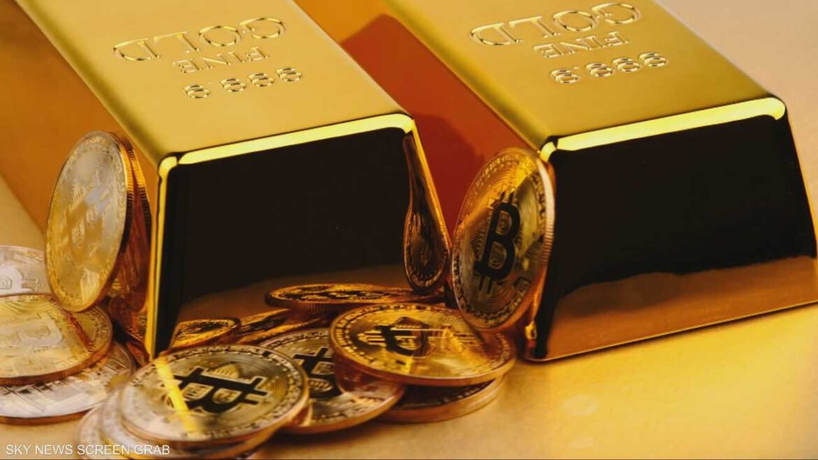 Gold bars with scattered coins, including Bitcoin symbols, on a yellow-gold surface (Sky News screen grab).