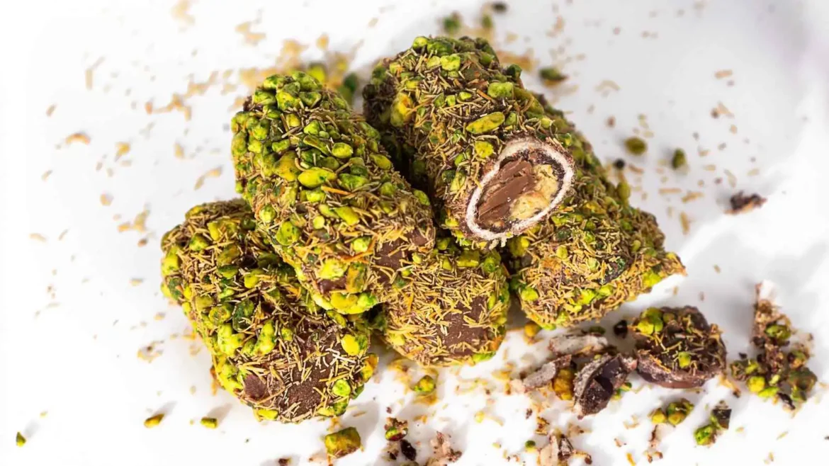 Chocolate truffles coated in crushed pistachios and coconut with a creamy ganache center visible in cross-section.