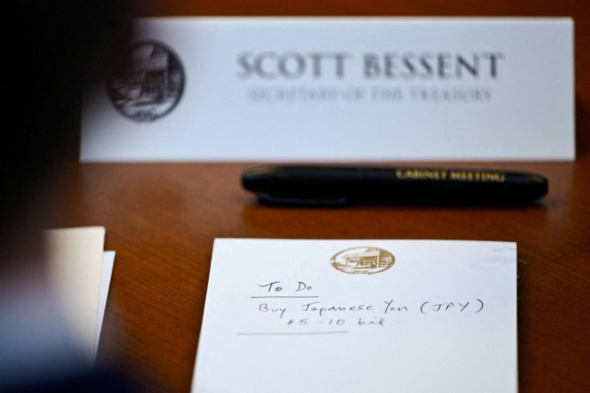 Scott Bessent business card on a desk with a black pen and a handwritten To Do note about buying Japanese yen (JPY).